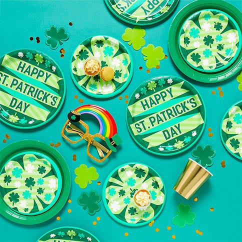 Green paper plates that say 'Happy St Patrick's Day' or have a shamrock design