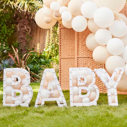 Neutral balloon mosaic letters spelling out baby, surrounded by a balloon arch